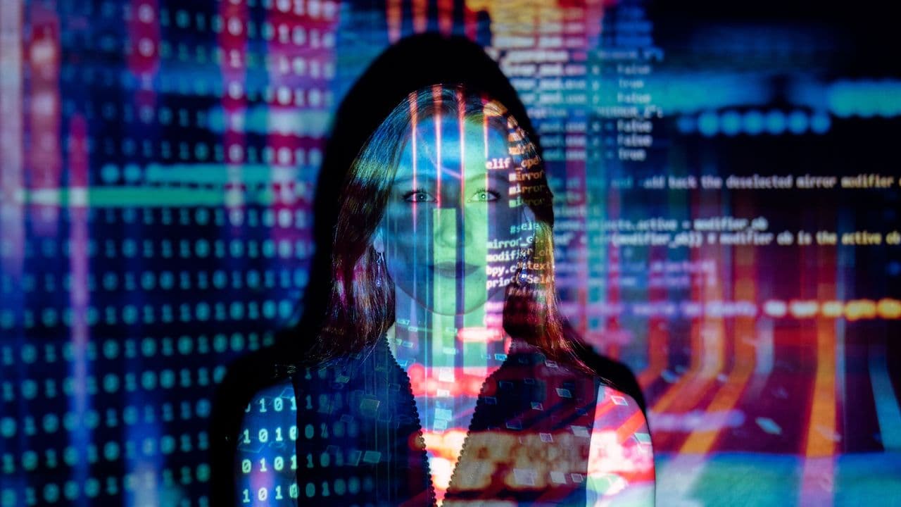 Mujer con proyecciones de código digital en su cara, representando tecnología y conceptos futuros